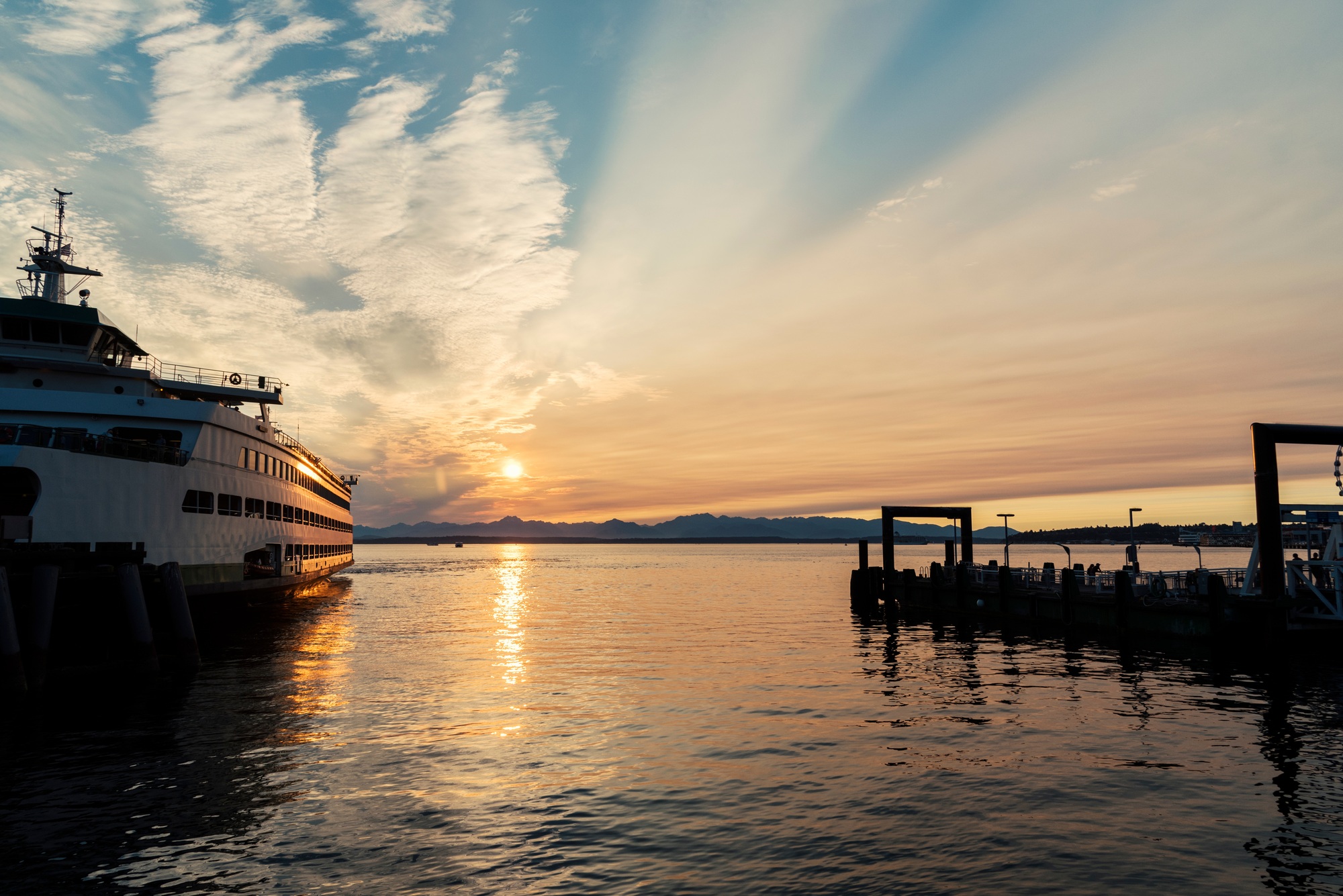 Waterfront marina with ferry boat at sunset